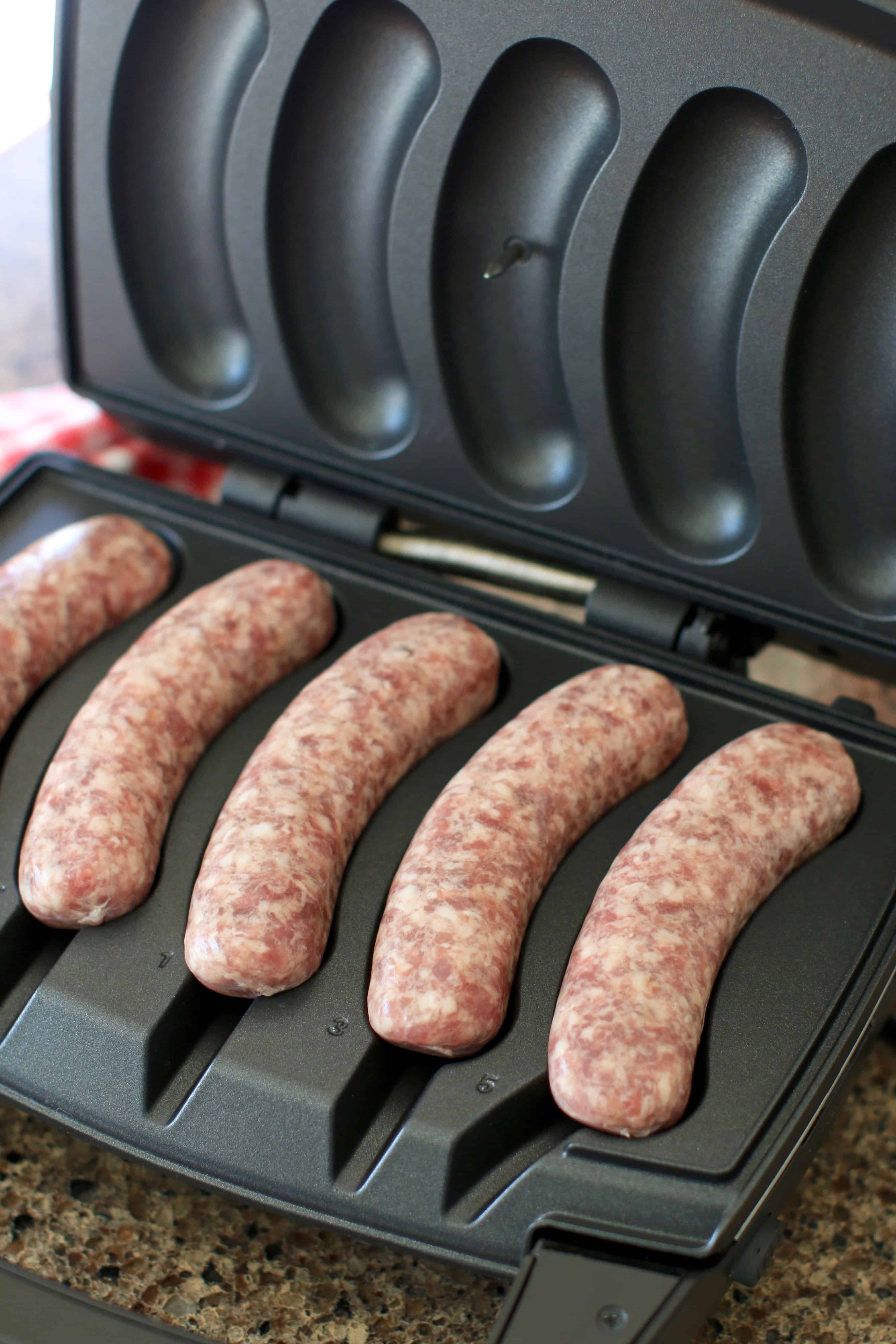 uncooked beer brats on Johnsonville Sizzling Sausage Grill.
