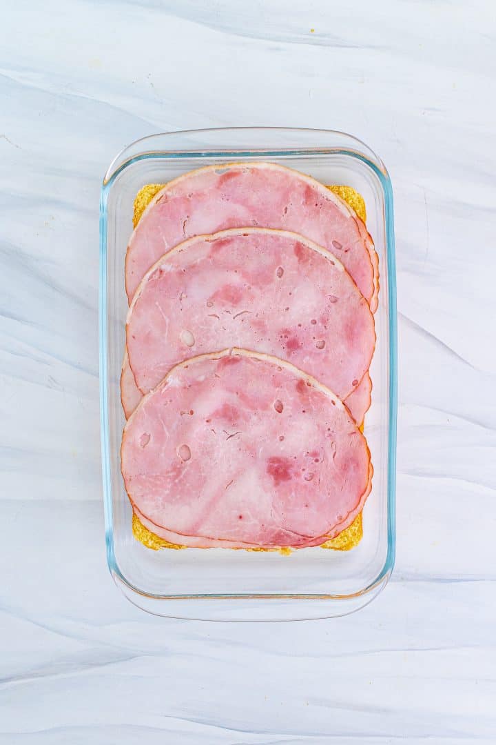 sliced ham layered evenly on slider buns.