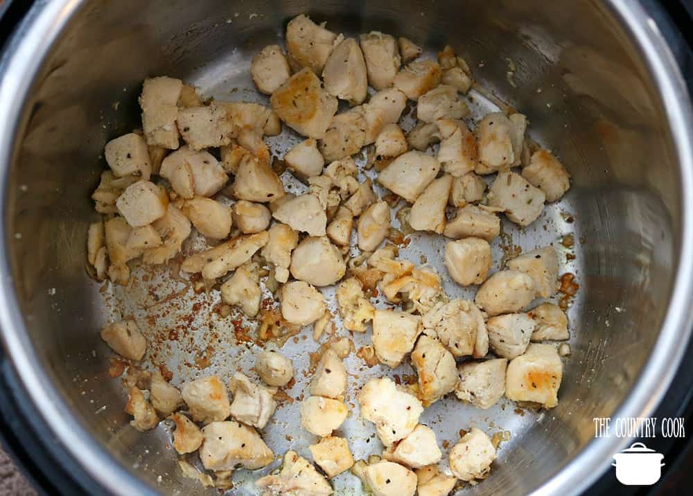 cooked chicken breast in the bottom of an instant pot electric pressure cooker.