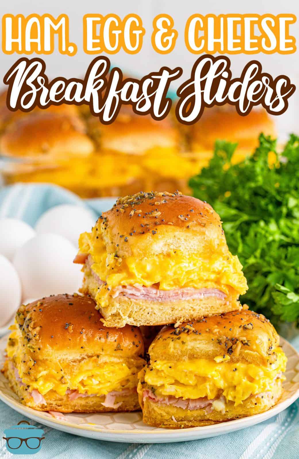 three breakfast sliders stacked on a small white plate.