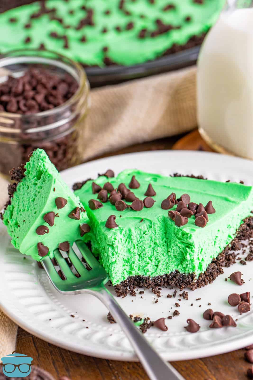 a slice of grasshopper pie on a plate with a bite removed. 