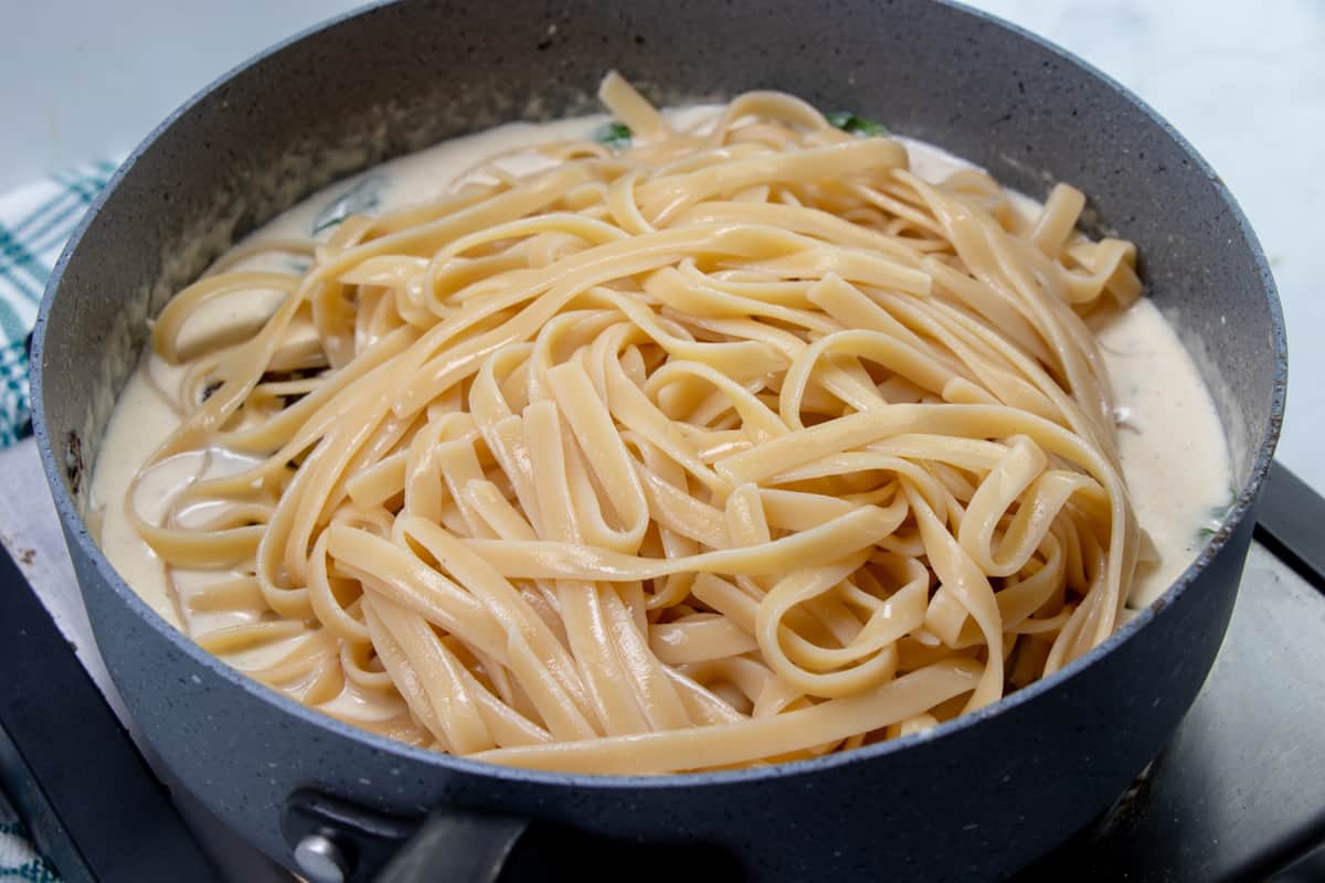 cooked fettuccine noodles and cooked baby Bella mushrooms added to creamy garlic sauce.