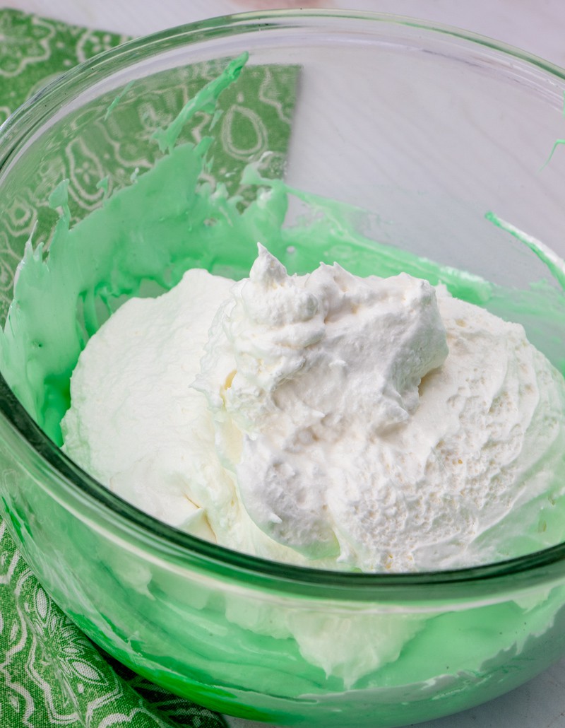 whipped topping combined with marshmallow fluff in a large bowl.