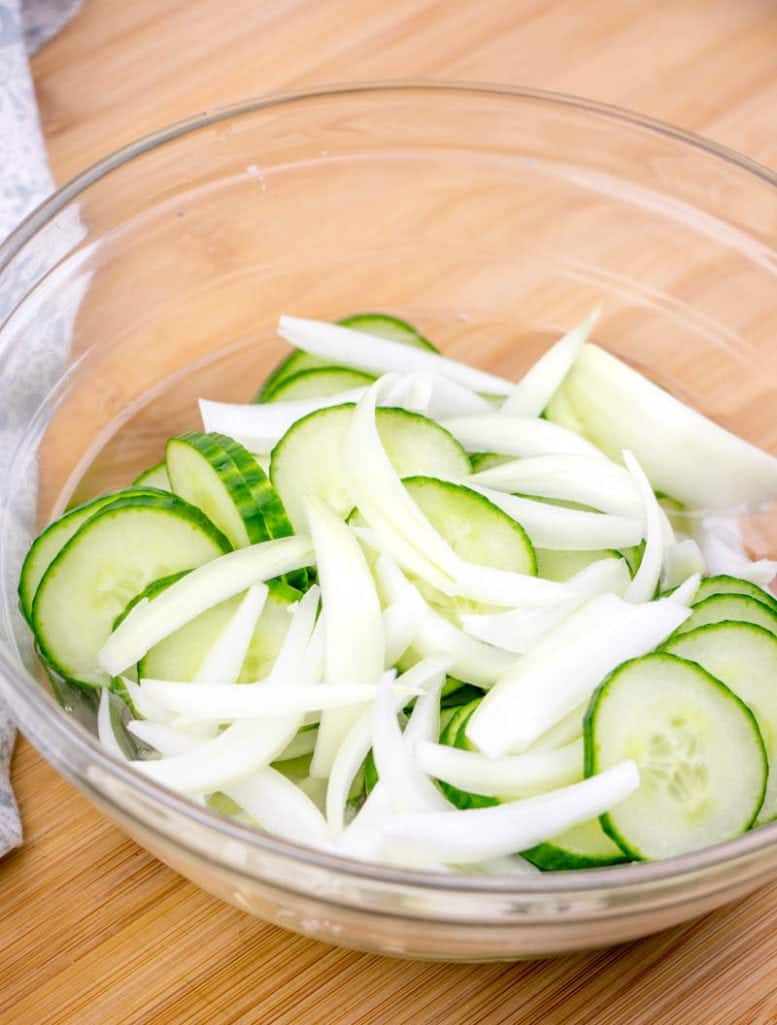 sliced cucumber and onion in a bowl