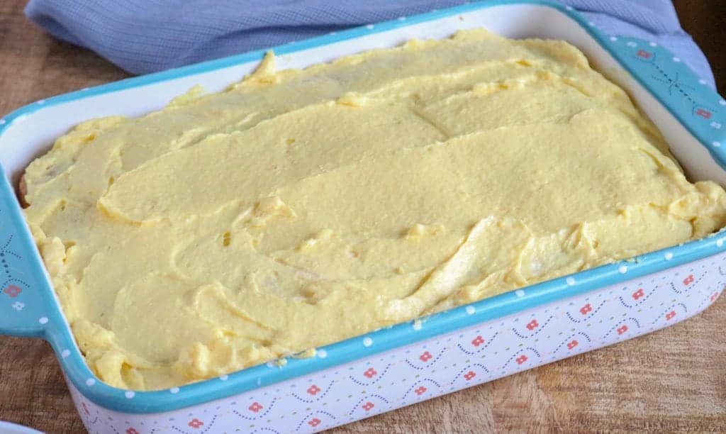 prepared vanilla pudding poured on top of baked cake