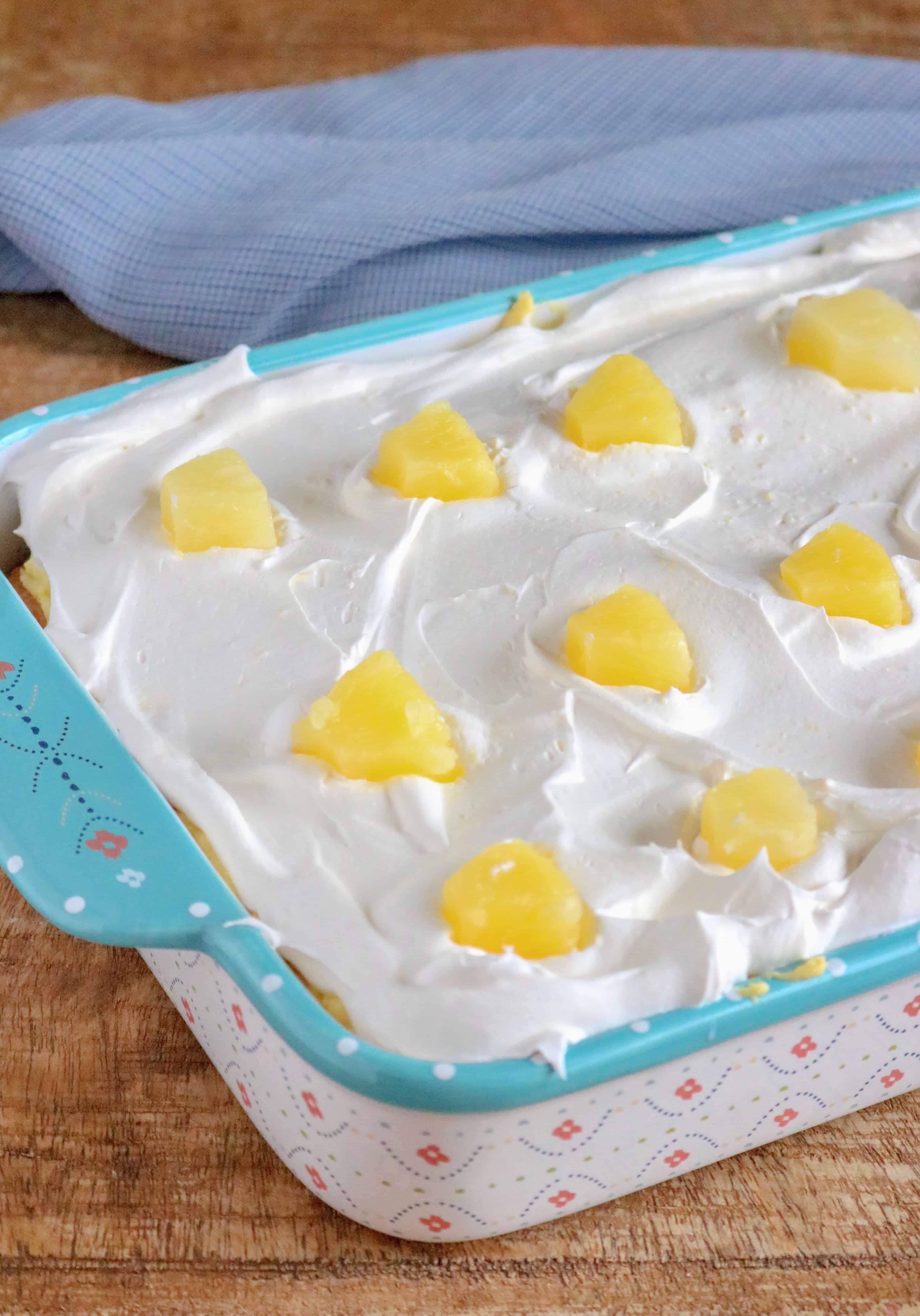 Cool Whip and pineapple chunks on top of pineapple slices, whipped topping