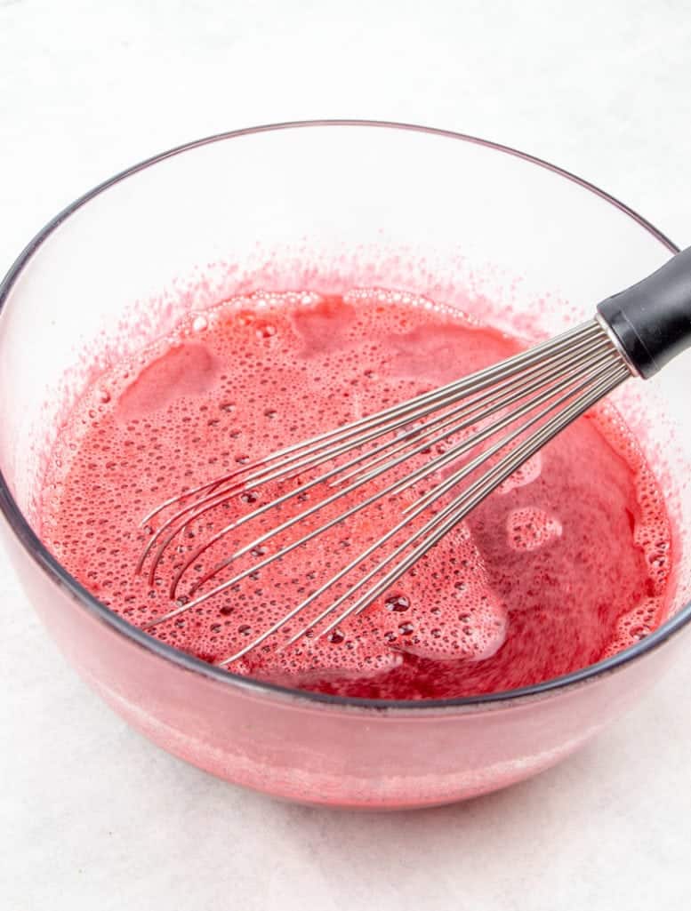cherry Jell-O whisked together with boiling water in a bowl
