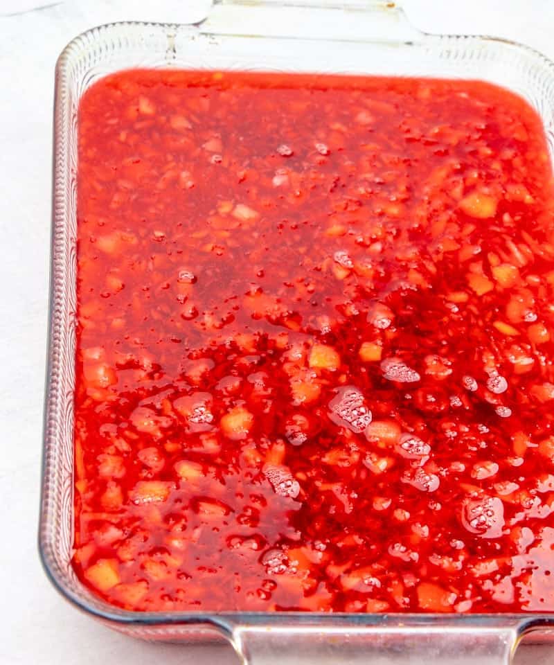 cherry gelatin, cherry pie filling and crushed pineapple in a 9x13 clear baking dish
