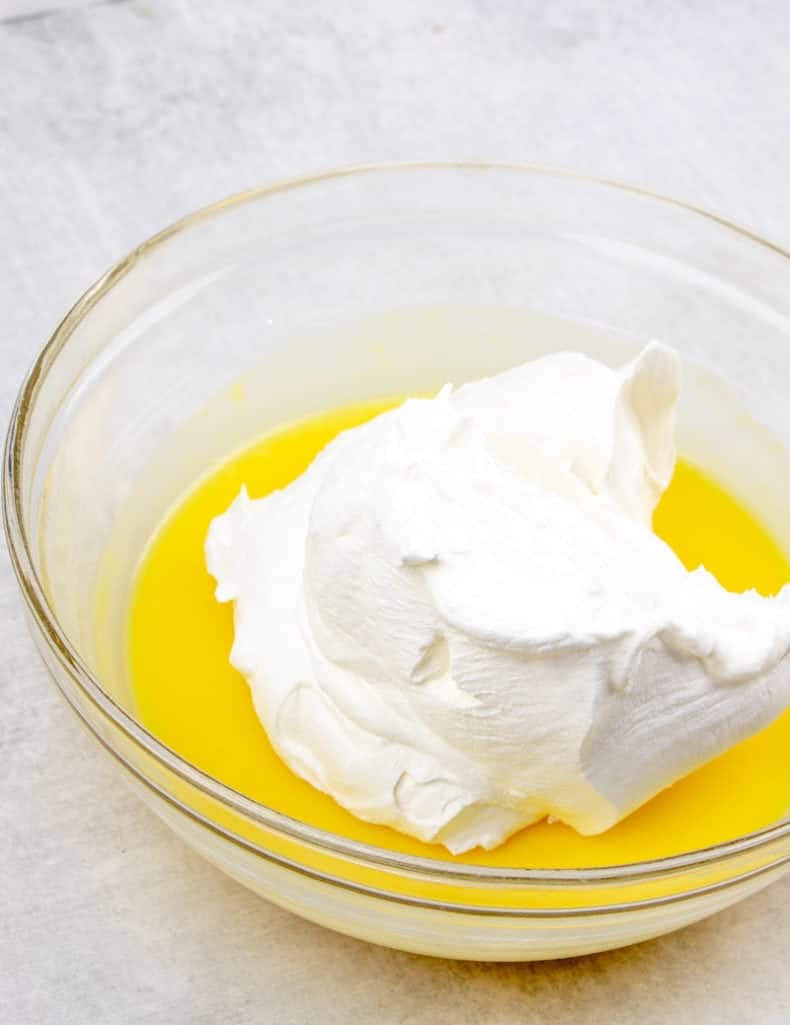 Cool Whip mixed together with instant vanilla pudding and milk in a bowl