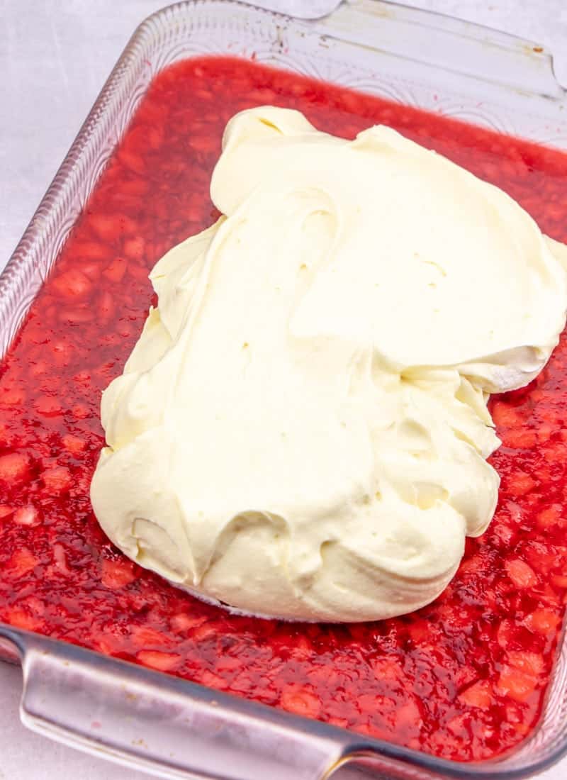 vanilla cool whip topping spread onto cherry gelatin
