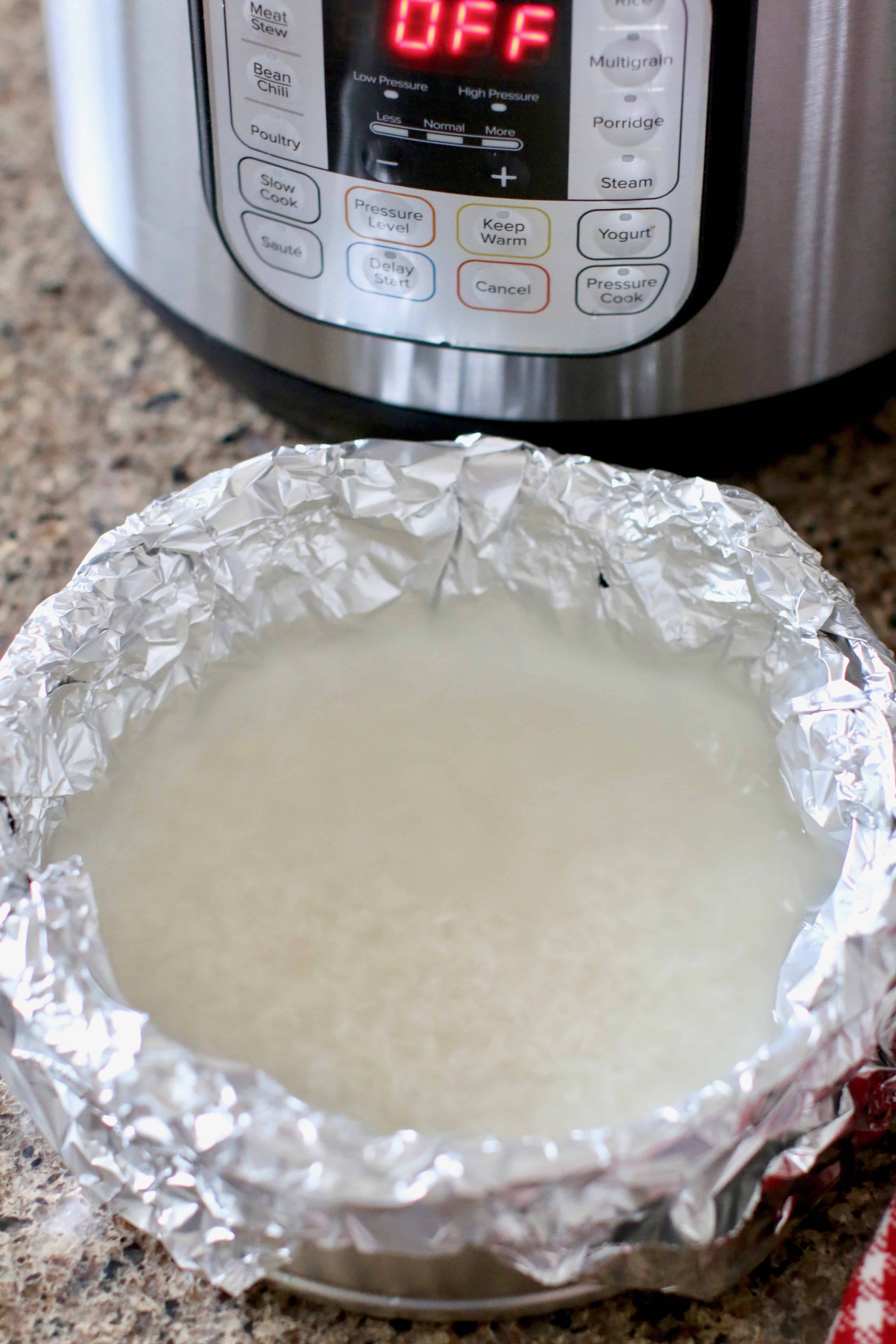 rice covered with water In a baking pan.