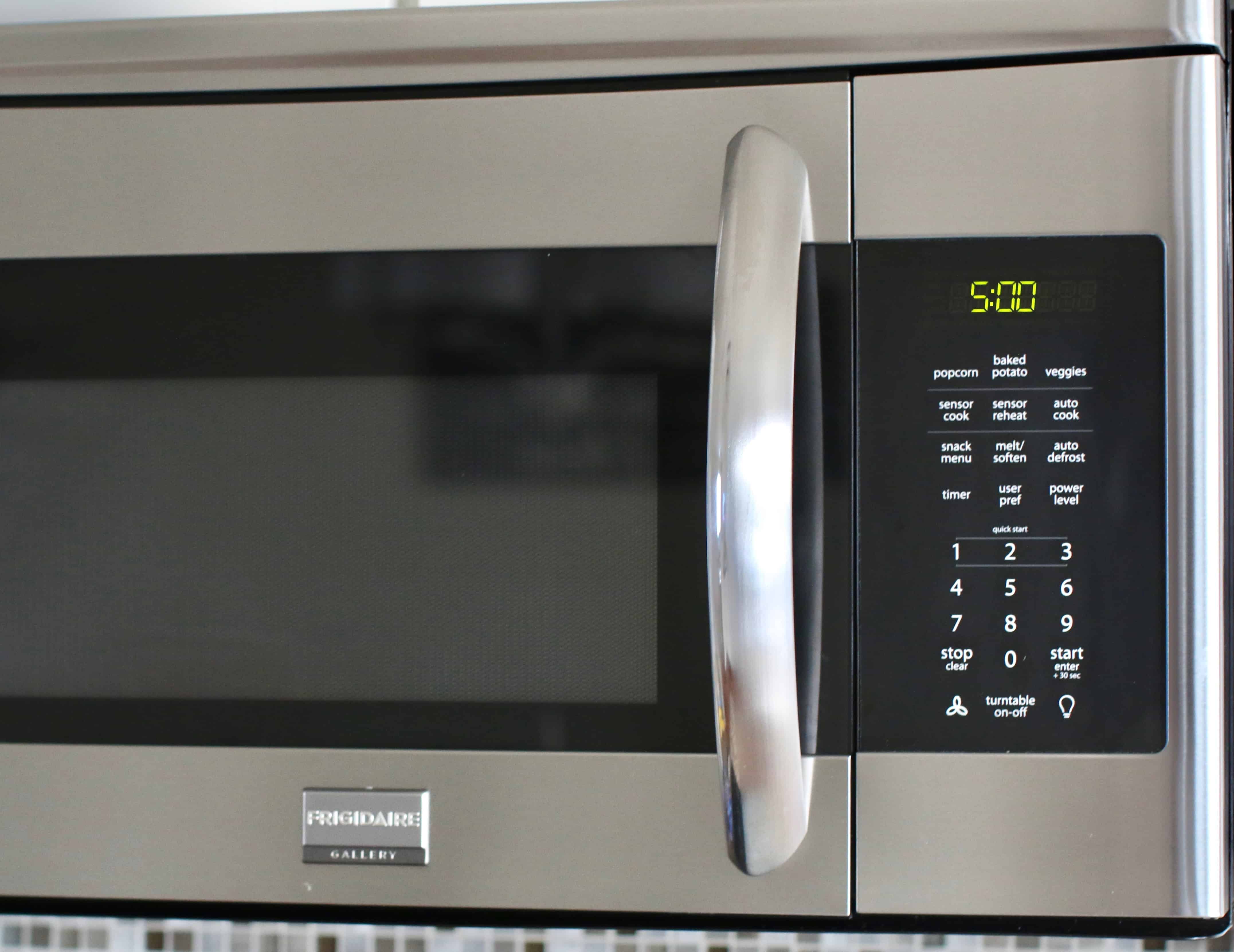 a microwave showing a 5 minute cooking time on the display.