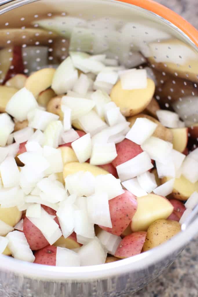 Diced little potatoes and diced onion in an Instant Pot steamer basket