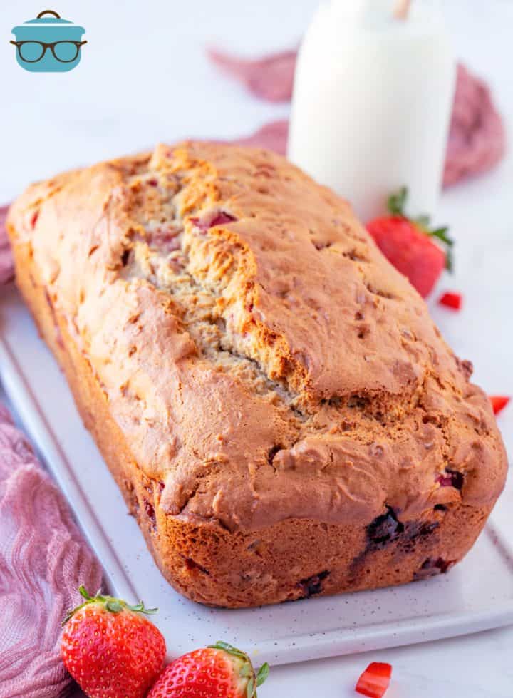 loaf of strawberry bread shown on a platter. 