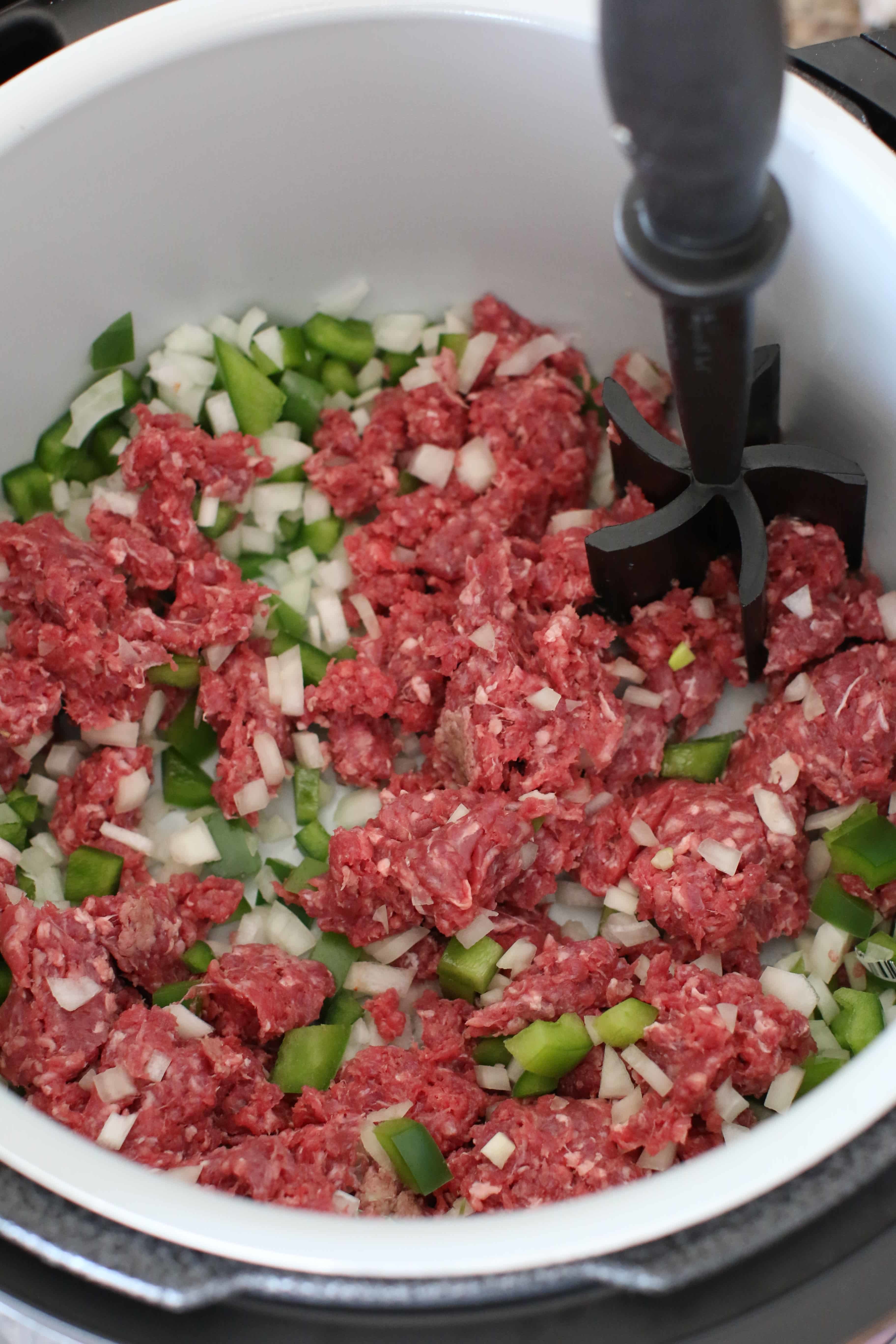 browning ground beef, onion, green pepper in an 8-quart pressure cooker.