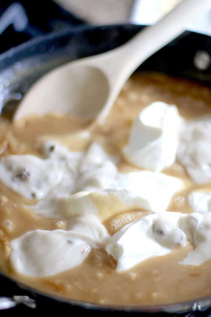 sour cream and cream of mushroom soup added to brown gravy in a large skillet