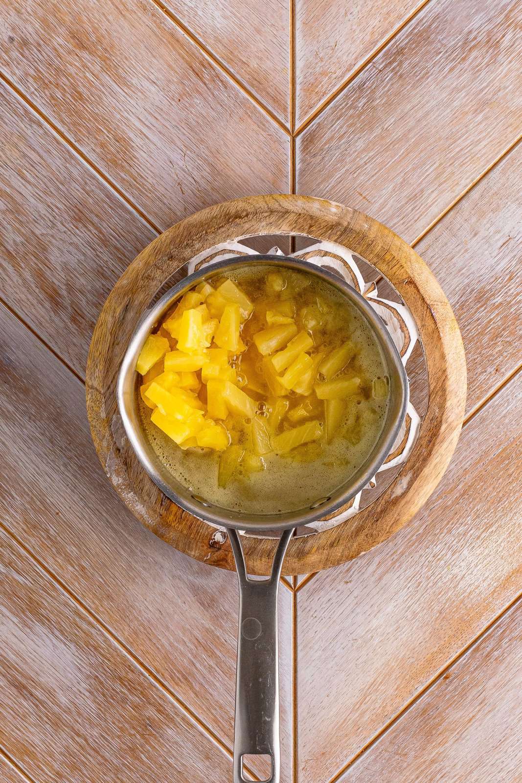 pineapple tidbits added to sauce pan. 