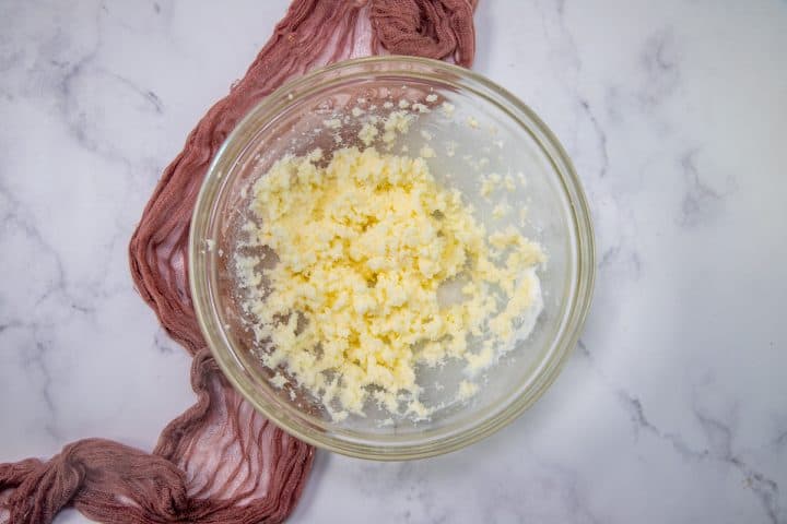 butter that has been creamed with an electric mixer in a clear bowl.