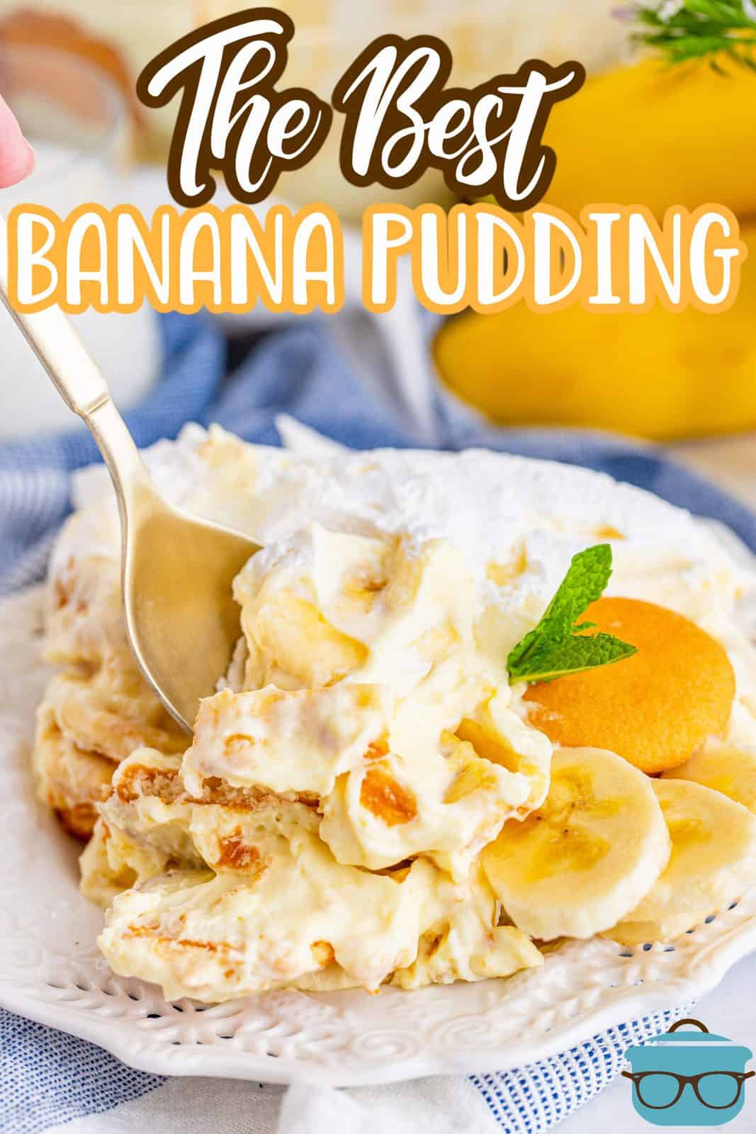 The Best Banana Pudding recipe from The Country Cook, serving of banana pudding on a small white plate with a spoon inserted into pudding.