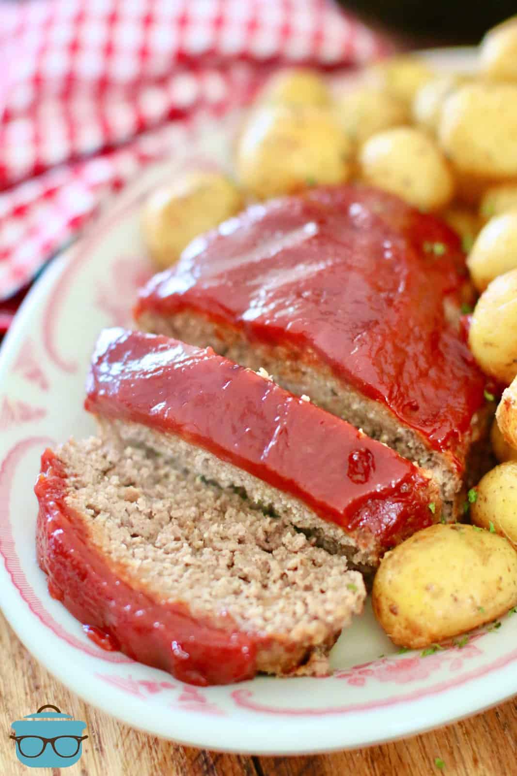 sliced meatloaf and baby gold potatoes on an oval plate.