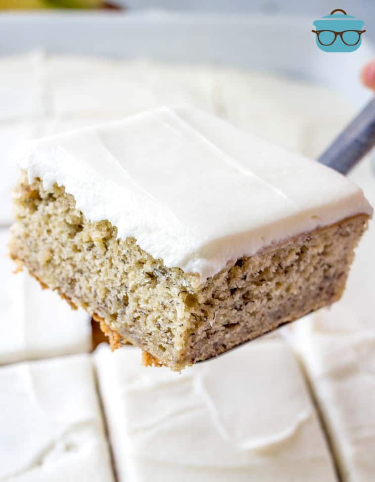 a slice of banana cake being held up by a spatula.