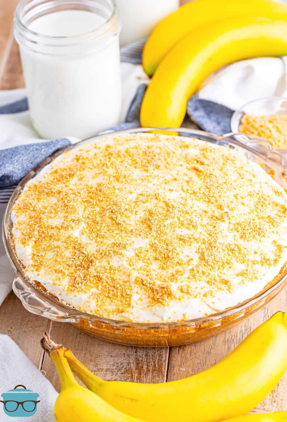 fully finished Banana Pudding Pie with bananas surrounding it. 
