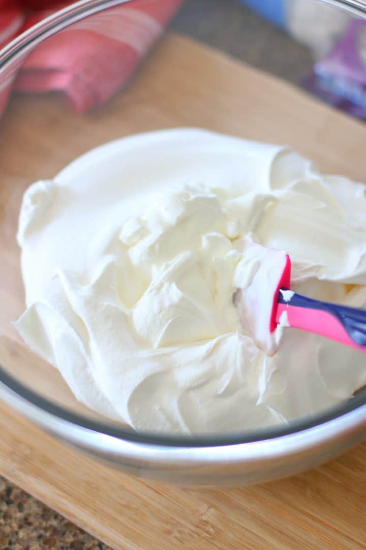 sour cream and whipped cream in a large glass bowl.