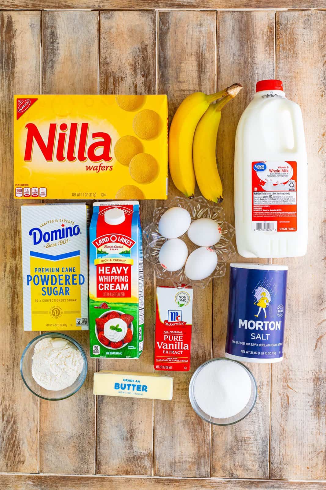 Nilla wafers, bananas, whole milk, eggs, bananas, heavy cream, powdered sugar, vanilla, salt, sugar, butter and flour. 