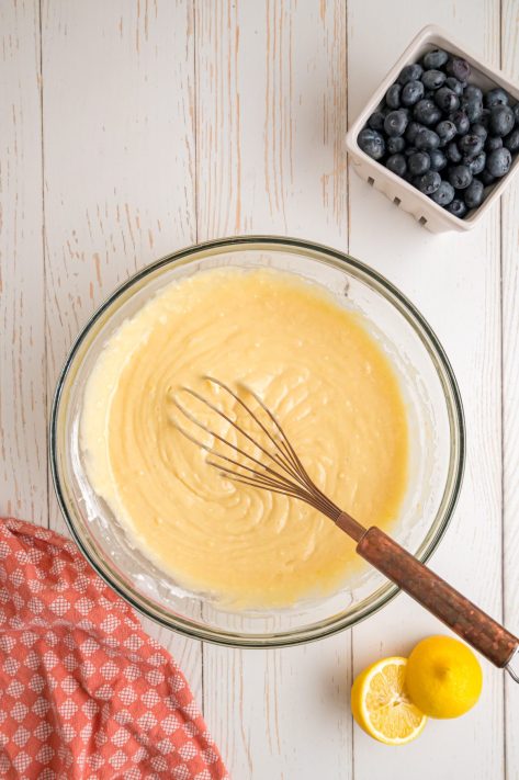 A bowl with a batter and a whisk.