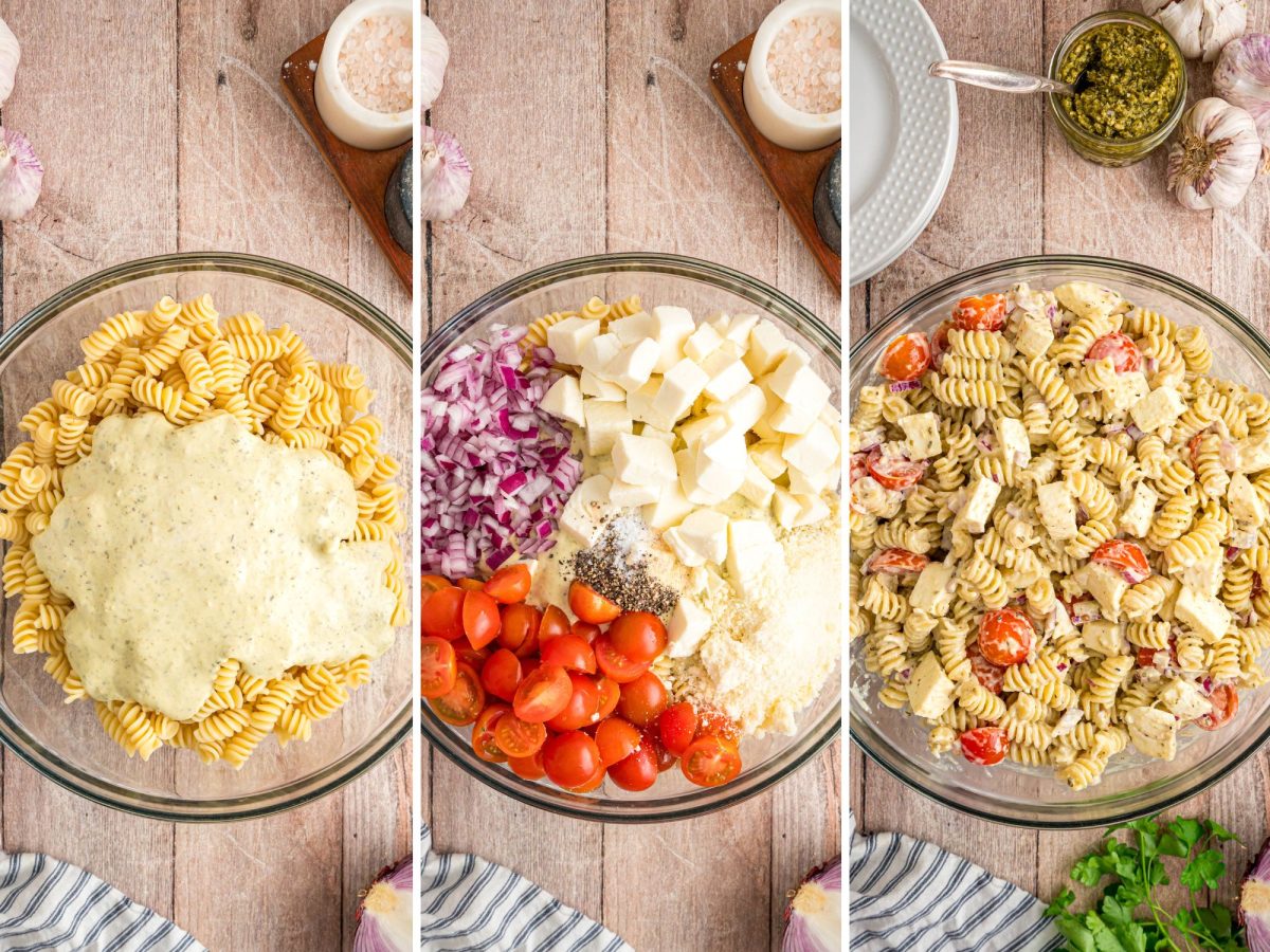 Pasta salad being mixed together in a glass bowl.