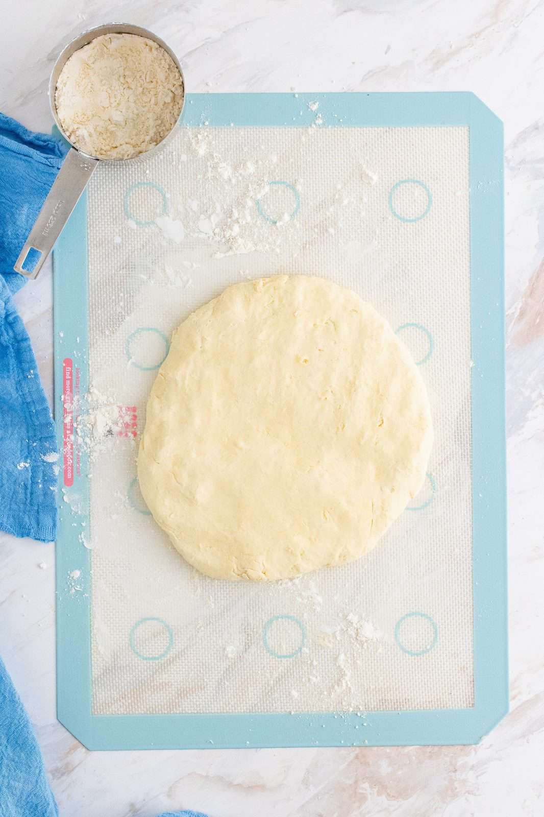 this biscuit dough in a large circle on a silicone baking mat.