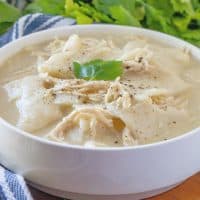 Old-Fashioned Chicken and Dumplings, shown in a bowl with parsley in the background