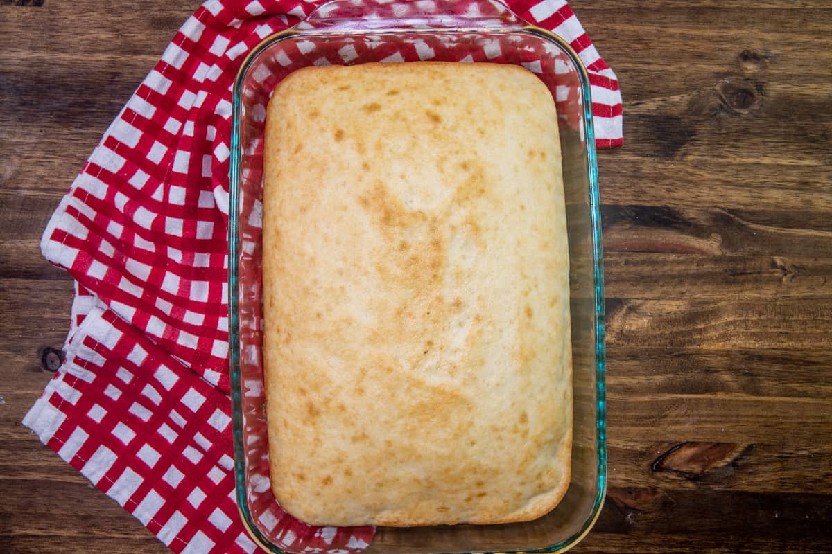 prepared white cake mix in a clear 9 by 13 baking dish.