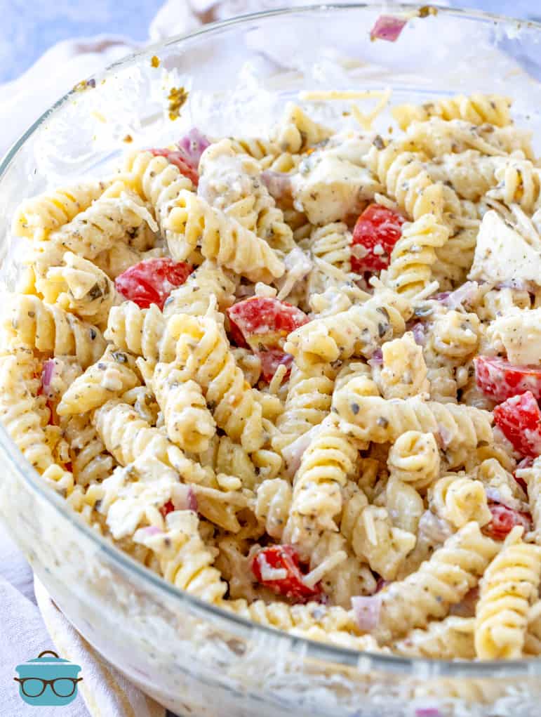 finished pasta salad in a large clear bowl.