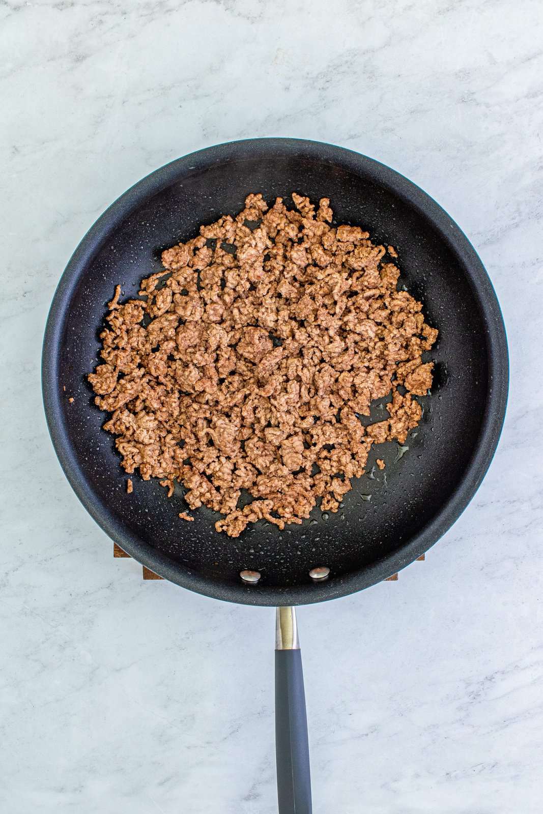browning ground beef in skillet.