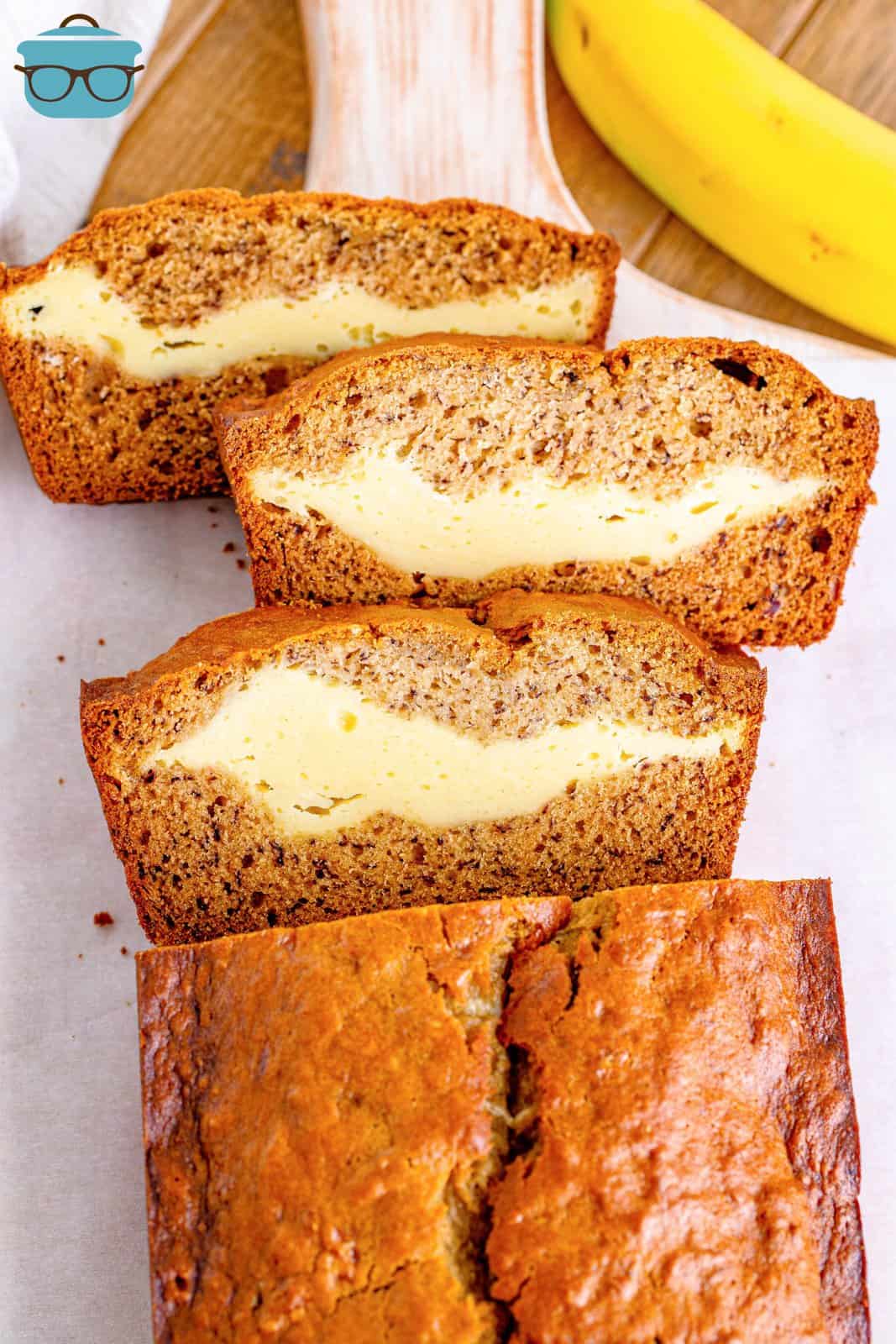 slices of cream cheese banana bread on a white platter.