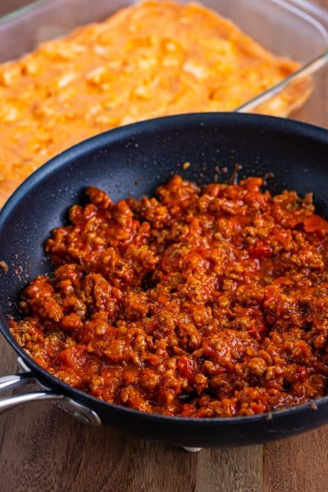 Sausage and spaghetti sauce mixed in a skillet.