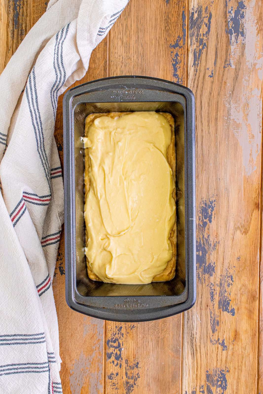 cheesecake batter layered on top of banana bread batter in a loaf pan.