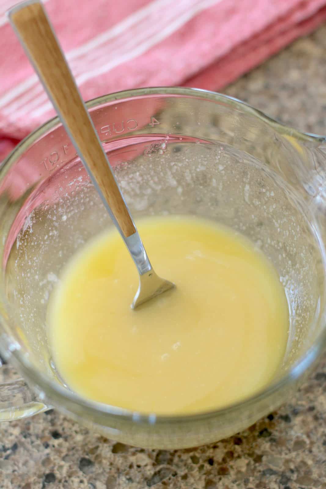 butter, sugar , flour and vanilla extract mixed together in a glass bowl