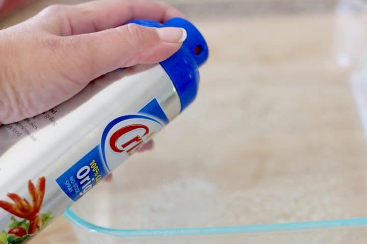 spraying a glass baking dish with Crisco nonstick cooking spray