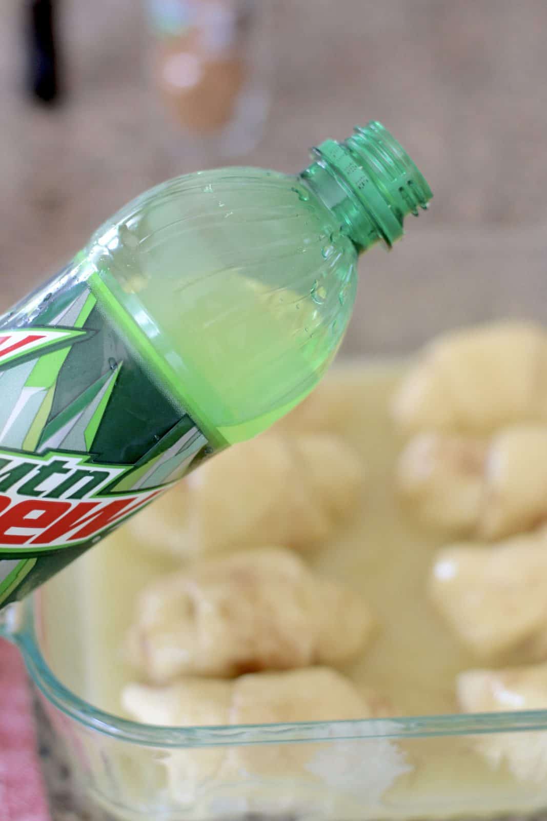 pouring Mountain Dew on top of the crescent roll bundles