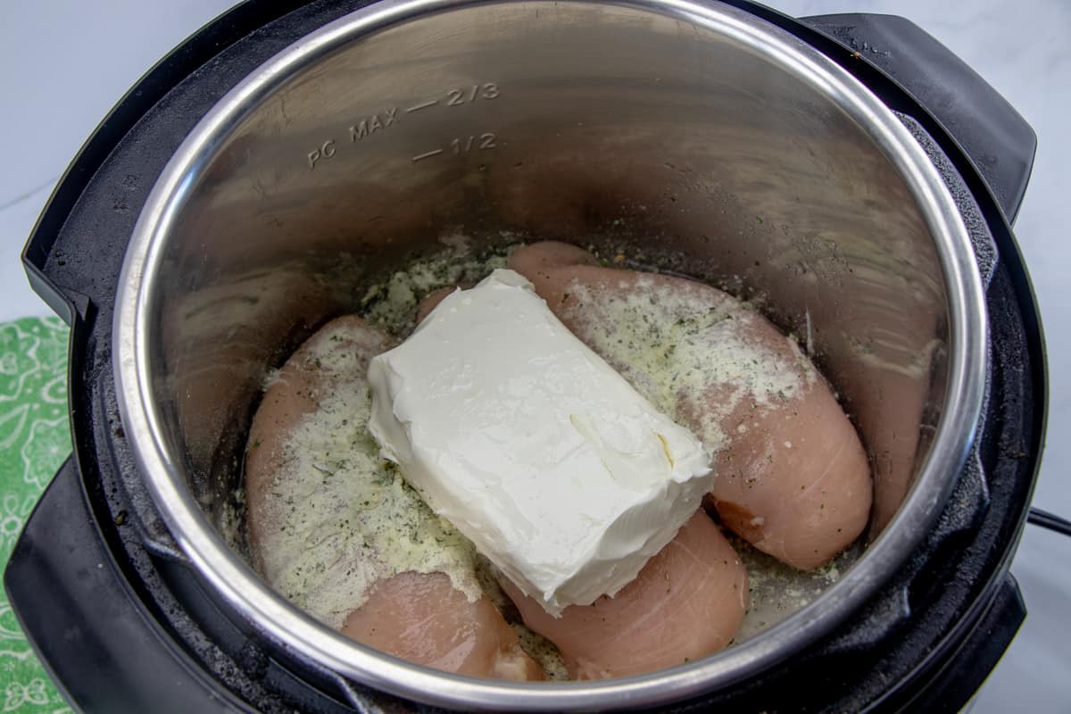 chicken breasts, ranch seasoning in the bottom of an instant pot insert