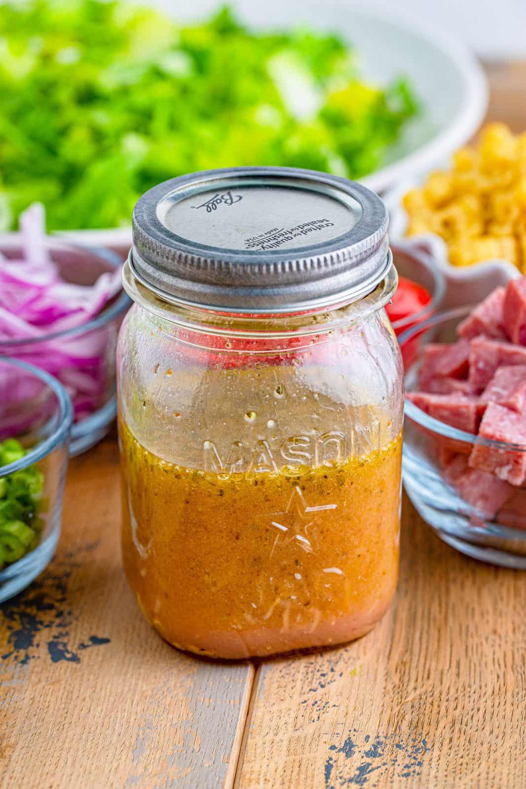 prepared salad dressing shown completely combined in a mason jar.