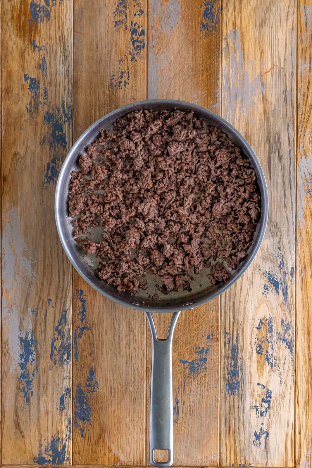 browning and crumbling ground beef in a large skillet.