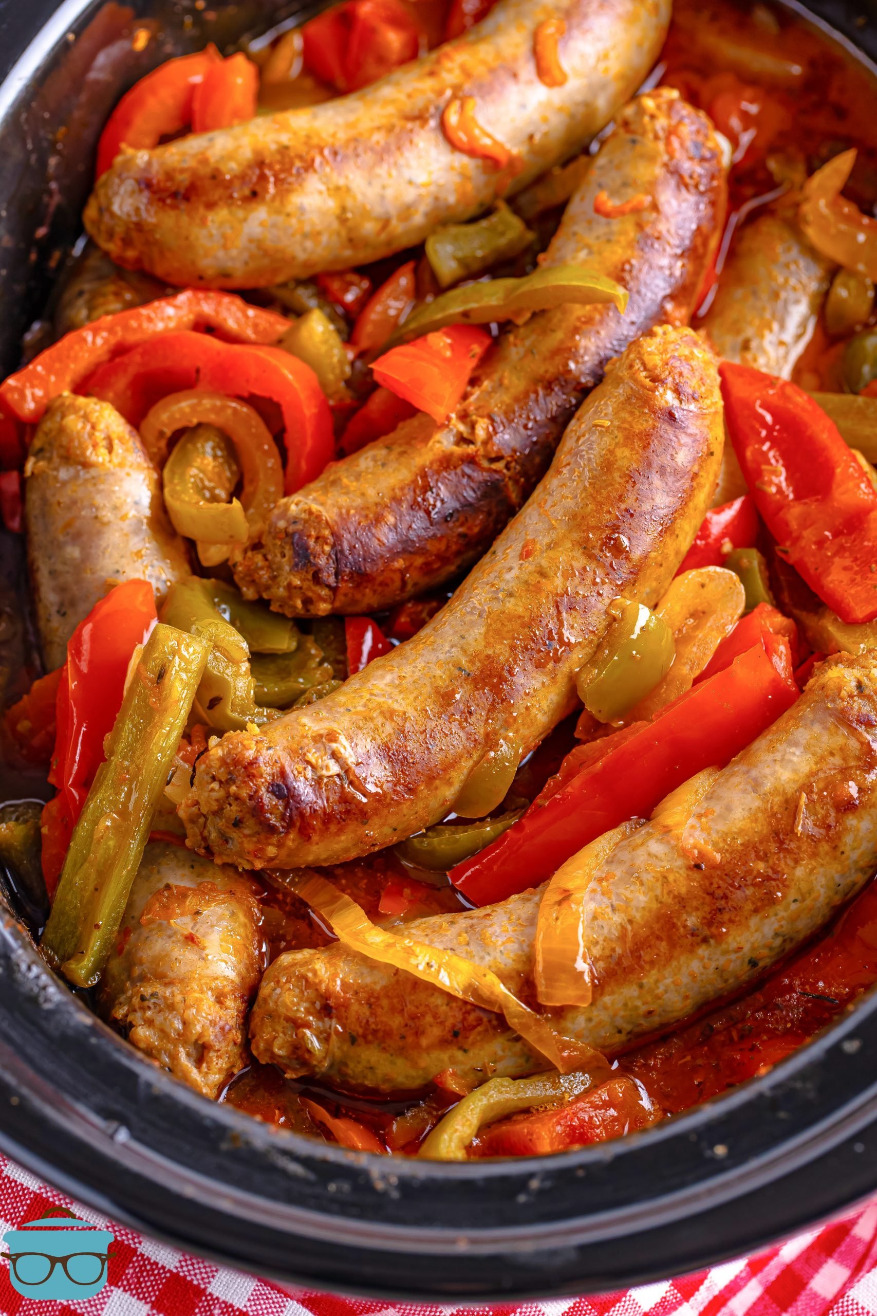 Close up looking at Sausage and Peppers in a slow cooker.