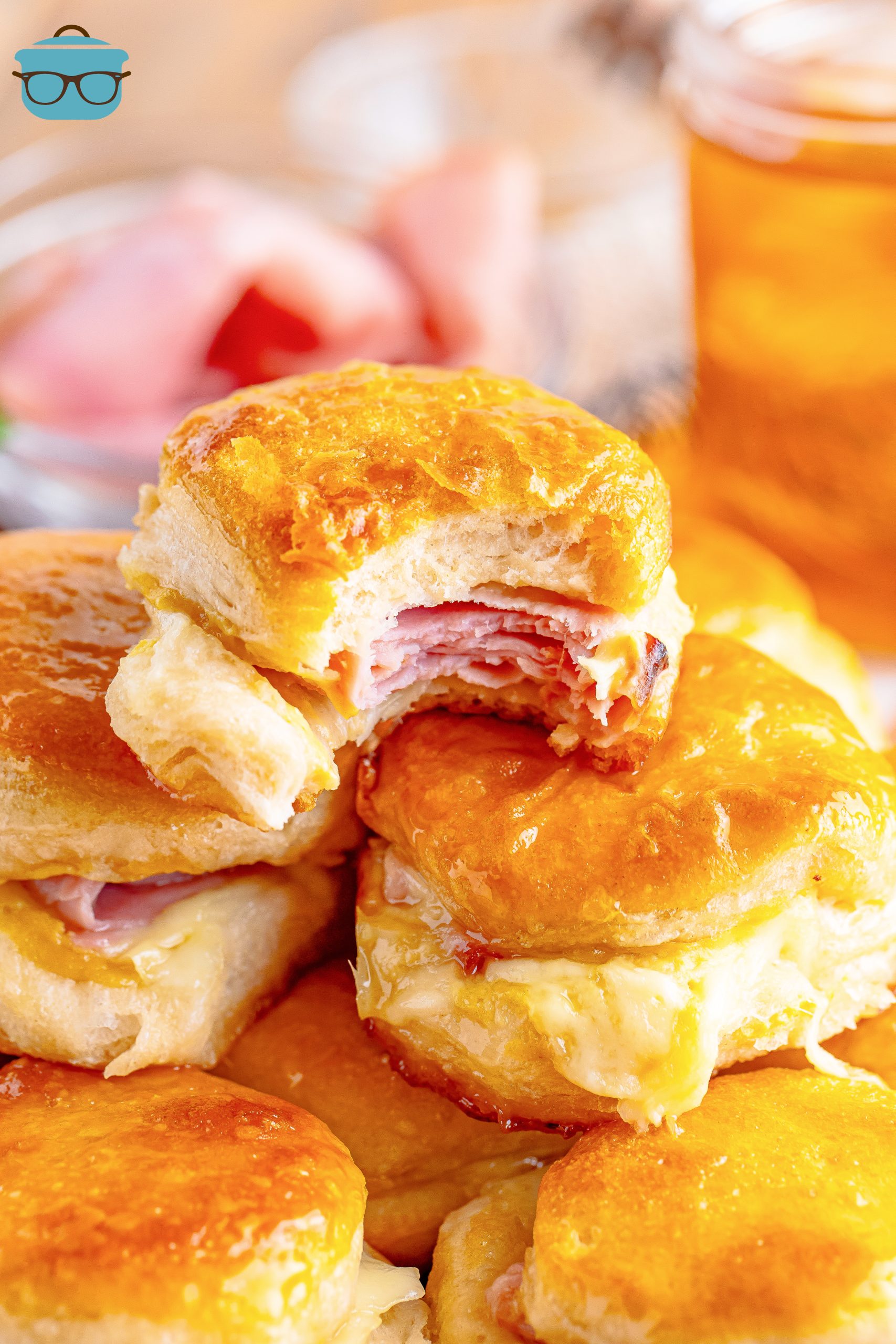 A few Honey Ham Biscuits in a pile, the top one missing a bite.