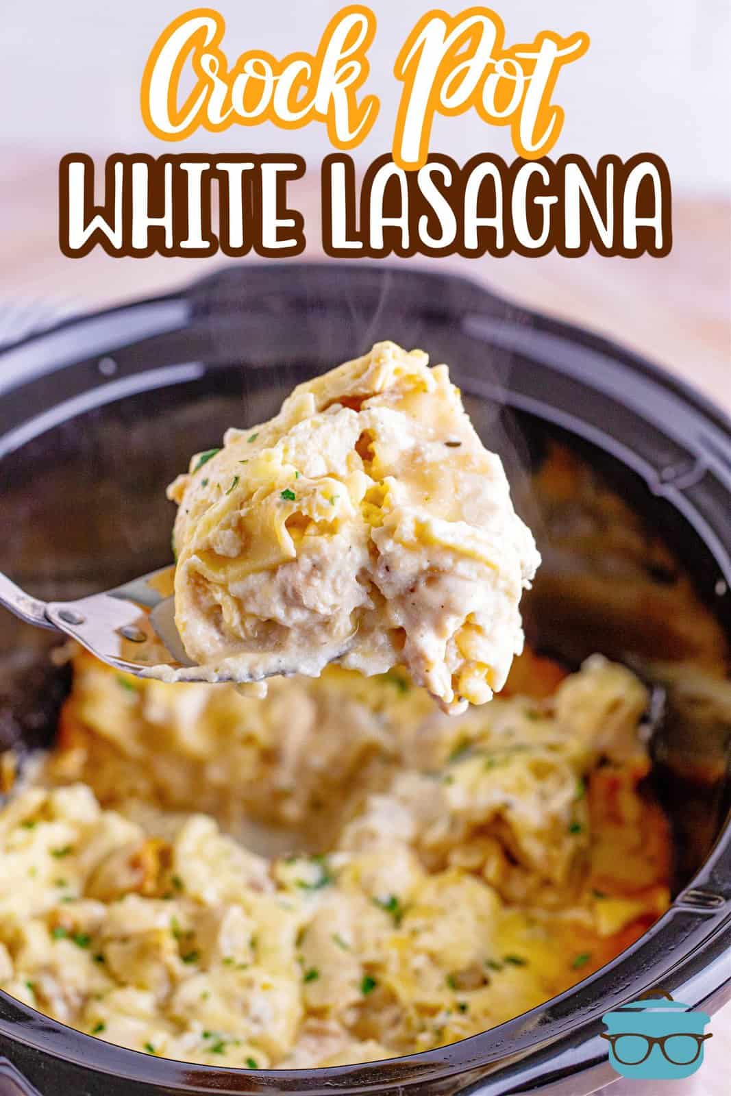 a large spoon scooping up a piece of white chicken lasagna over an oval slow cooker. 