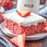 Easy Fresh Strawberry Cake on a white plate with a milk jug in the background