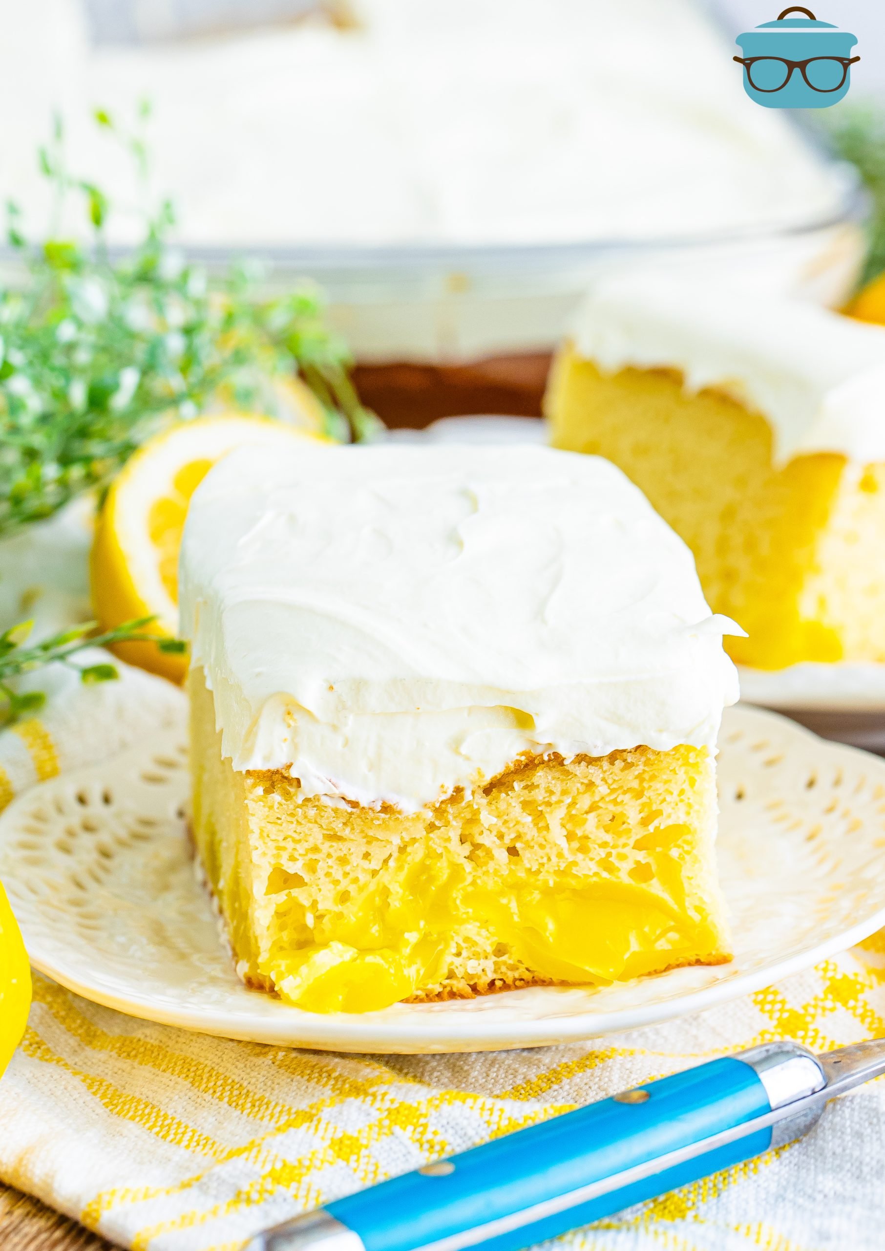 A small slice of Lemon Dream Cake on a white dessert plate. 