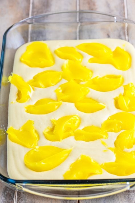Vanilla cake mix with globs of lemon pie filling on top.